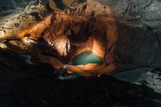 Discover the breathtaking beauty of an illuminated underground cave with a serene water pool in Новый Афон.
