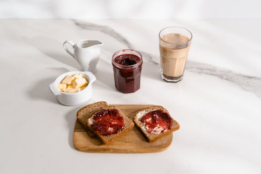 Delicious breakfast with toast, jam, and coffee on a sunny morning table.