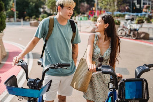 Happy couple with bicycles enjoying a sunny day in the city, smiling and interacting.