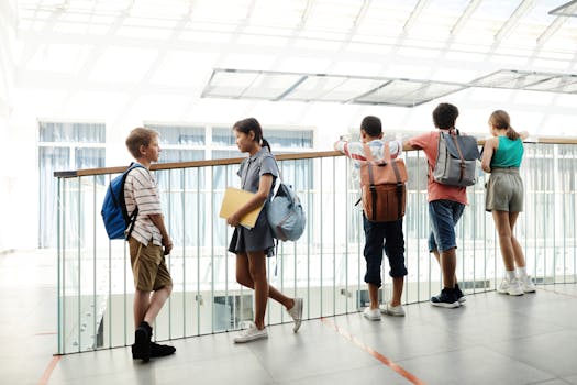 A group of diverse students chatting in a bright school hallway, carrying backpacks.