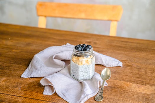Healthy chia pudding with blueberries and coconut on a rustic wooden table. Perfect for breakfast.