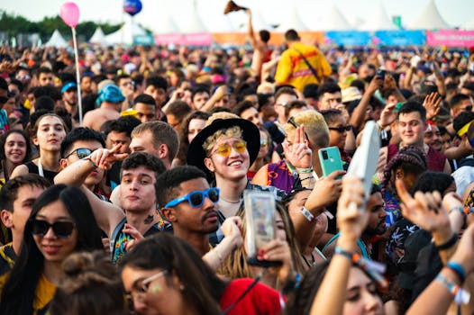 A lively crowd of diverse young adults enjoying an outdoor music festival, capturing the vibrant atmosphere.