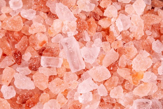 Macro image showcasing the detailed texture and color of pink Himalayan salt crystals.