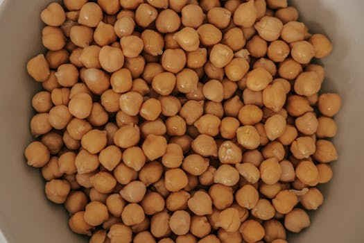 A detailed overhead shot of fresh chickpeas in a bowl, perfect for culinary uses.