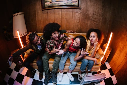 A fun gathering of diverse friends sitting on a vintage couch indoors.