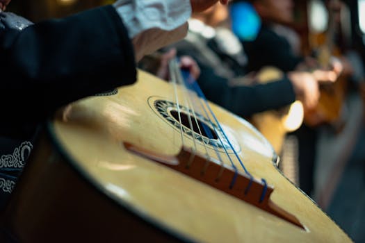 A detailed close-up of a guitar played by a mariachi musician, showcasing traditional music in Mexico.