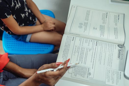 An educational scene with a teacher guiding a student through a textbook.