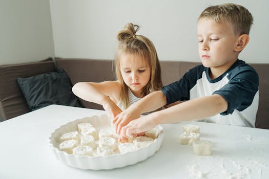 Children enjoying a fun bonding moment as they bake cookies at home.