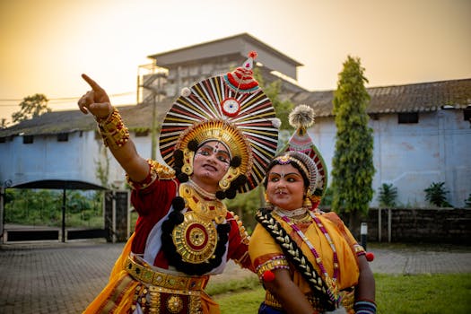 Colorful depiction of Indian classical dance performers in traditional attire outdoors at sunset.