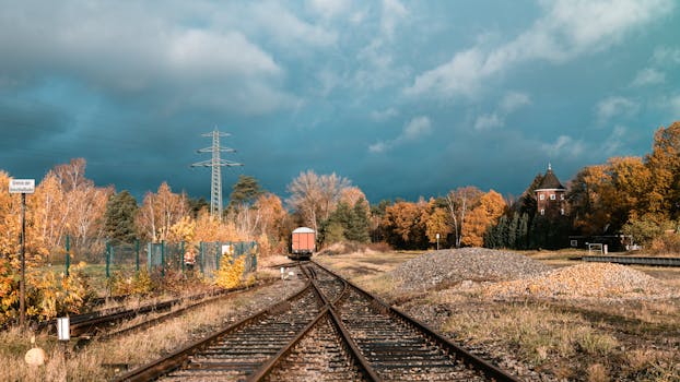 A picturesque railway scene in autumn with vibrant fall foliage in Geesthacht, Germany.