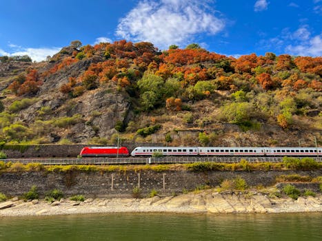 Train travels through Oberwesel's autumn landscape along the Rhine River.