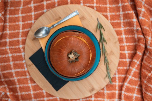 Top view of a traditional pumpkin dish served with utensils. Perfect for autumn meals.